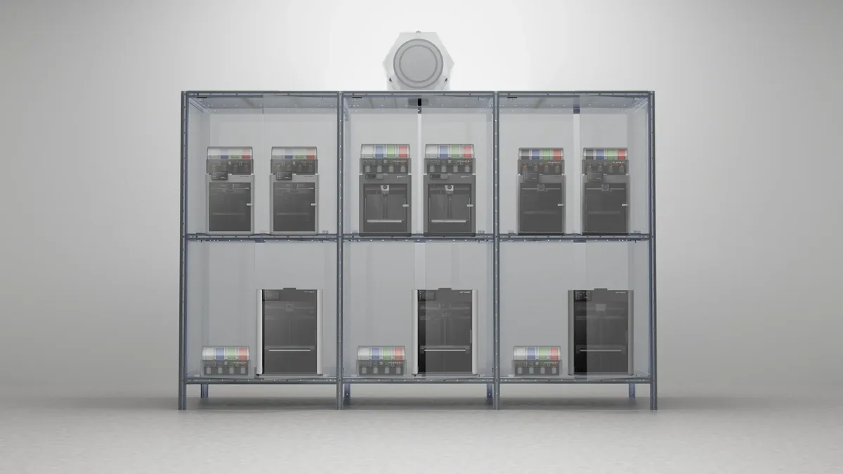 Six loaded bays holding nine printers and their filament systems, doors removed.
