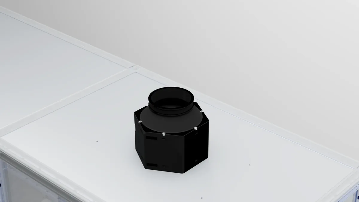 The optional extraction fan seated on the enclosure roof plate.